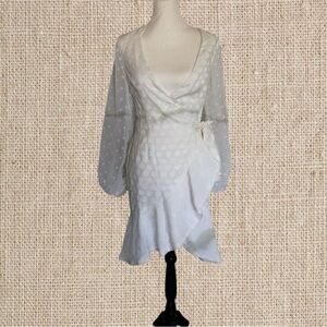 Cute wraparound white dress with a ruffle detailing